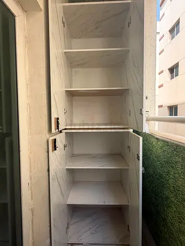Tall white storage cabinet with multiple shelves - good condition