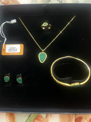 Gold-tone matching necklace, bracelet, ring and earrings set with green inlay