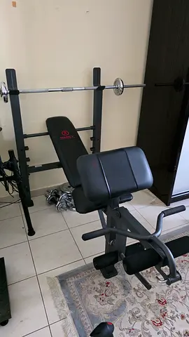 Used multi-function home gym bench with squat rack and barbell