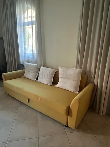 Mustard yellow 3-seater sofa bed in good condition