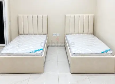 New Pair of single beds with mattresses — beige upholstered frames