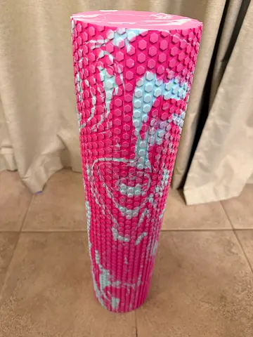 Pink textured foam roller for massage and myofascial release