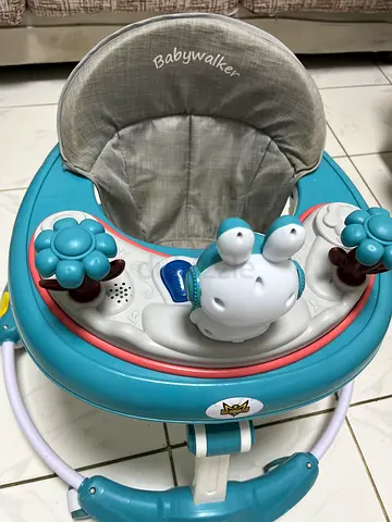 Lightly used blue baby walker with music and toys