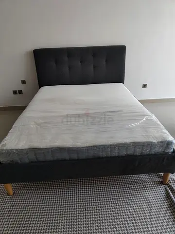 Queen bed frame with mattress — modern grey upholstered, like new
