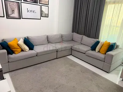 Light grey L-shaped sectional sofa with cushions - good condition