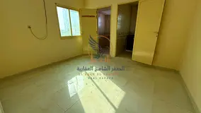 Unfurnished monthly studio in Al Bustan, Ajman, separate kitchen, bills included, no cheques.