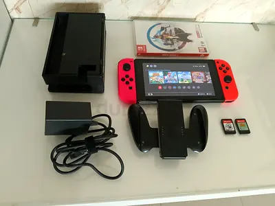 Nintendo Switch 2 console with dock, Joy-Con, charger, wheel grip and 2 games