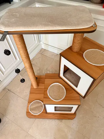 Wooden multi-level cat tree with scratching posts and beds