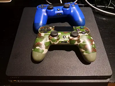 Sony PS4 Slim with 2 DualShock 4 Controllers (Blue + Camo)