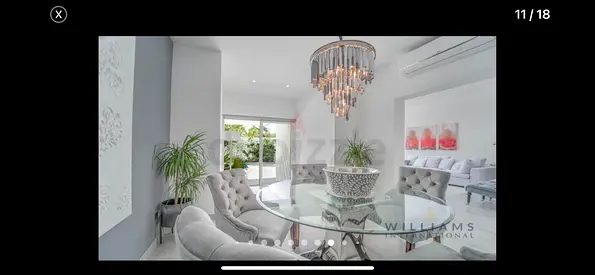 Glass Top Dining Table with stainless steel leg + pendant lamp from Marina Home Interiors.
