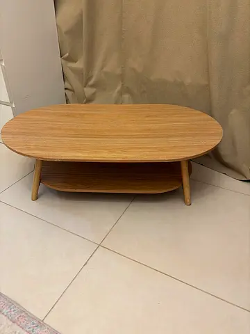 Oval wooden coffee table with lower shelf — good condition