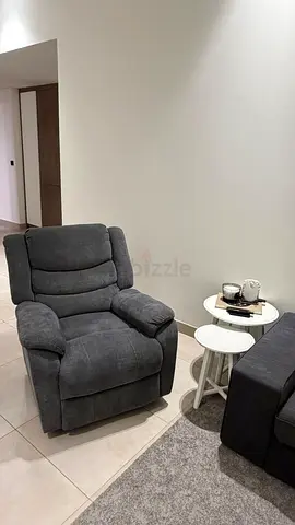 Comfortable grey recliner armchair in good condition