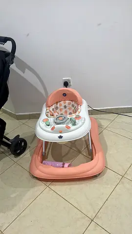 Lightly used pink baby walker with activity tray