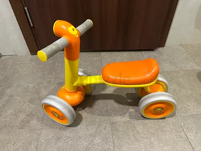 Small orange-yellow ride-on toddler bike - good condition