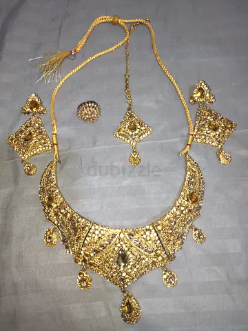 Gold-tone traditional necklace set with matching earrings and tikka