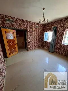 Spacious studio for annual rent in Al Butina, Sharjah. Features a semi-separate kitchen, central ai