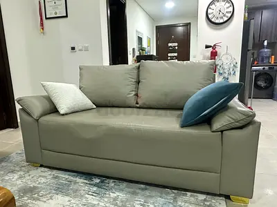 Two-seater grey leather sofa in good condition