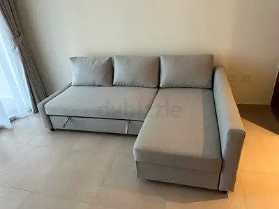 Light grey L-shaped 3-seater sofa bed with chaise