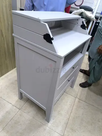 Compact grey wooden baby changing table with storage drawers