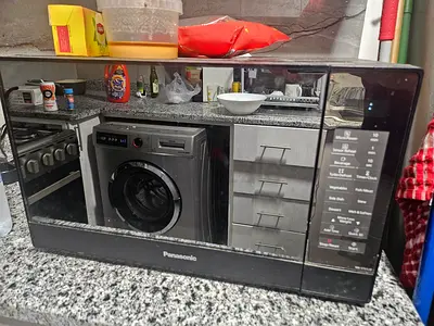 Panasonic countertop microwave oven with mirrored finish — used
