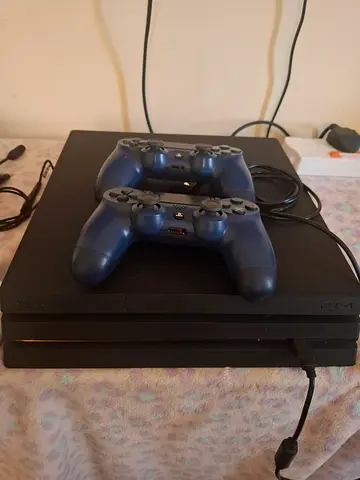 Sony PlayStation 4 Pro with 2 DualShock 4 Controllers - Good Condition