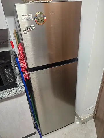 Stainless steel double-door refrigerator in good working condition