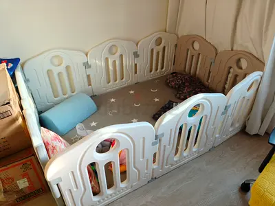 Baby playpen / safety play yard — foldable plastic panels, neutral beige/white