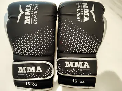 Few Days Used pair of black and white MMA Live Gym Dubai boxing gloves weighing 16 oz,