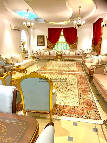 Villa for sale in Sharjah, Al Quiz area. The villa covers an area of 10,000 sq ft, consists of two floors, and has a covered parking that fits ten car