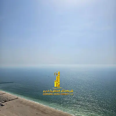 Two-bedroom apartment with a living room and a sea view for monthly rent at Corniche Residence Towers, Ajman | Includes bills, gym, pool, parking