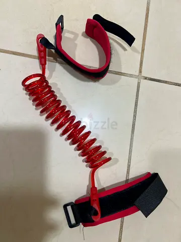Red coiled child safety wrist leash - used