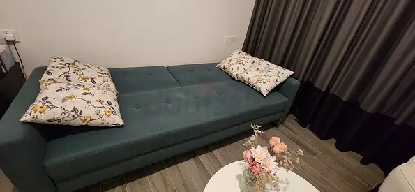 Convertible sofa bed / futon in teal — good condition