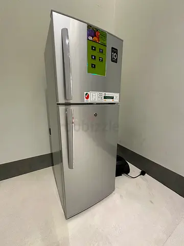 Silver double-door refrigerator with top freezer — good working condition