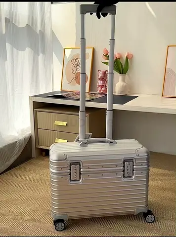 Rimowa pilot case silver hard-shell carry-on trolley suitcase with telescopic handle
