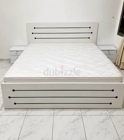 White double bed frame with headboard and two matching bedside tables