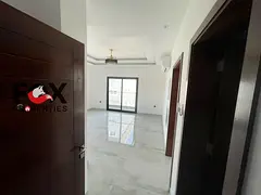 One-bedroom apartment with a living room for annual rent in Al Rashidiya 2, featuring a balcony and 