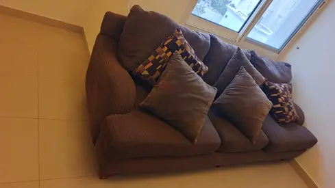 Comfortable 5 seater brown fabric sofa with cushions