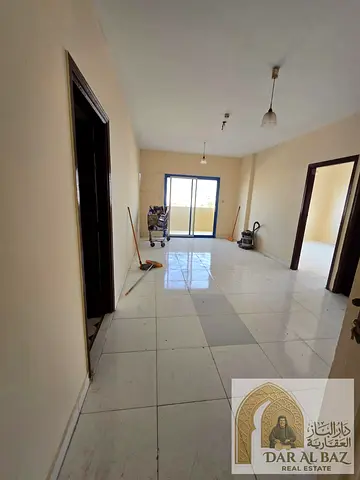 One-bedroom apartment with a living room and balcony, available for working professionals (bachelors) in Al Butina, Sharjah. Includes 15 days free of