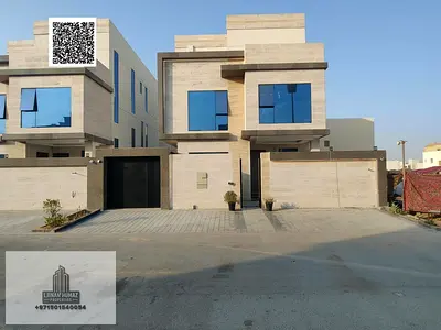 Villa for sale in Ajman, Al-Zahia area. 5 master bedrooms, majlis, living room, and maid's room. Ba