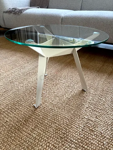 Small round glass side table with white tripod metal legs - Good Condition.