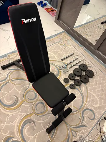 Adjustable workout bench with dumbbells and weight plates — excellent condition