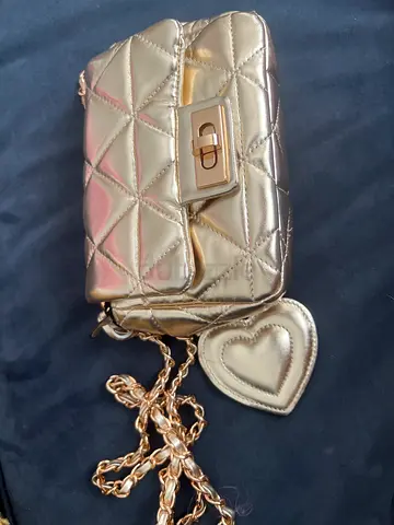 Small quilted metallic gold shoulder bag with chain strap and heart charm
