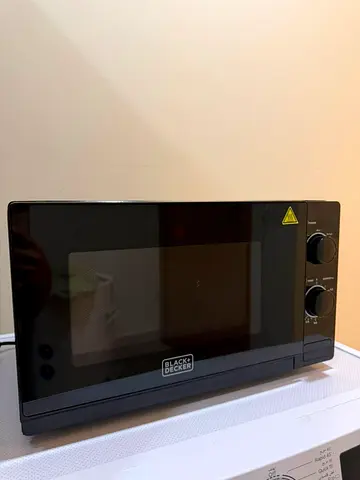 Used Compact Black Microwave Oven with Manual Controls