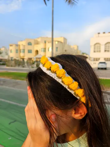 Handmade crocheted headband with yellow flower details