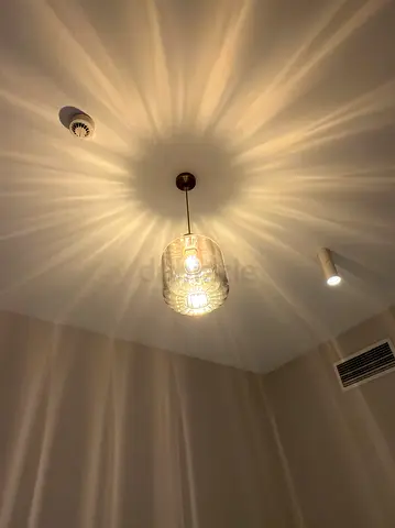 Glass pendant ceiling light with decorative starburst shadow effect