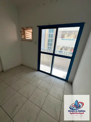 Annual studio for rent in Al Butina, separate kitchen, large space, central AC & gas, flexible payments, prime location, easy Dubai exit.
