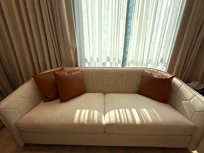 Light beige 3-seater sofa with nailhead trim — good condition