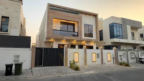 Luxury villa for sale in Al Zahia, Ajman. The property spans two floors plus a roof terrace and comes fully equipped with electricity, water, and air