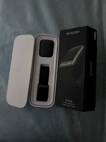 WHOOP 5.0 fitness tracker with the charger.