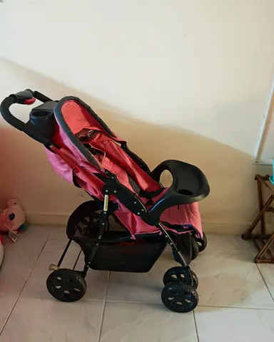 Pink lightweight baby stroller with tray and storage basket